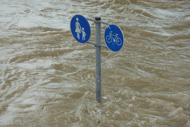 above angle shot of murky water with half submerged street sign